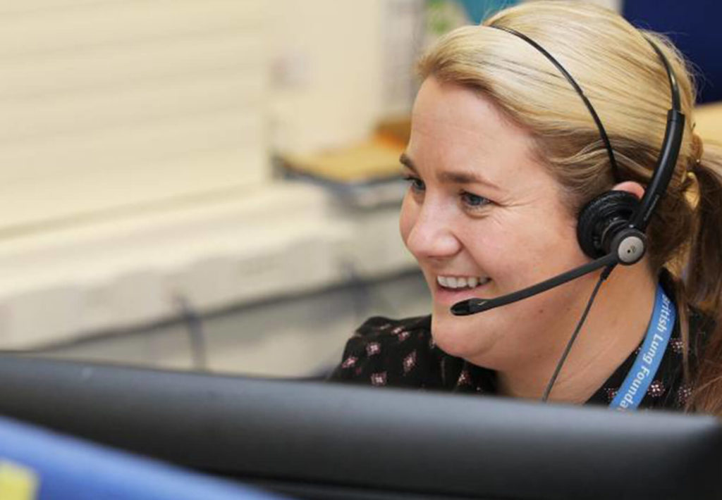 woman with a headset on helping people using a computer